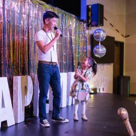 Dad and daughter singing karaoke