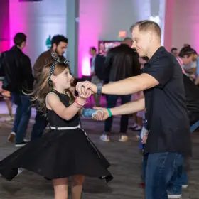 Dad and daughter dancing in ballroom