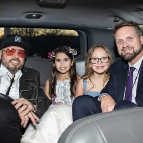 Dads and daughter riding in the limo