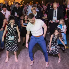 Dad and daughters dancing