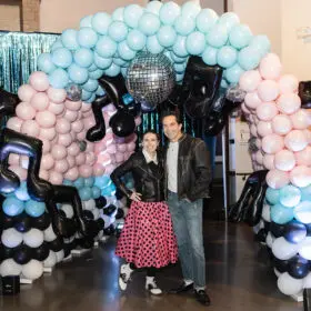 Dad and daughter with balloon arch stair entrance